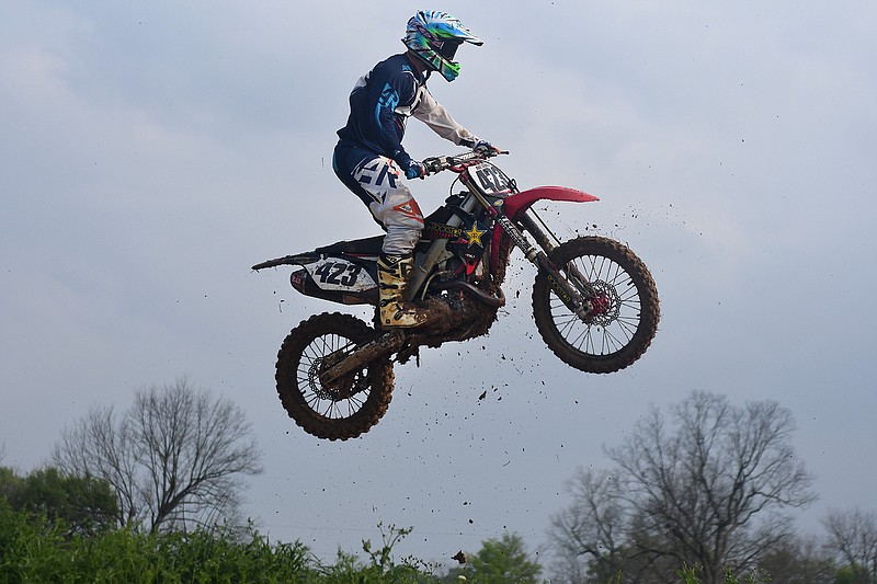 Stosh Skinner gets some air while riding dirt bikes with friends Tuesday at a private course off Summerhill Road 