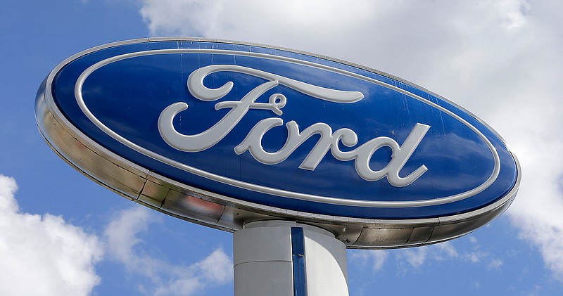 This Tuesday, Jan. 17, 2017, photo shows a Ford sign at an auto dealership in Hialeah, Fla. Ford Motor Co. is investing $1.2 billion in three Michigan facilities, including an engine plant where it plans to add 130 jobs. President Donald Trump applauded the move in an early morning tweet, Tuesday, March 28, 2017.