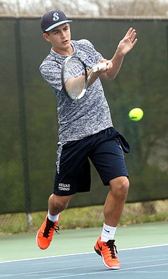 Dalton Buschjost of Helias makes a return during Tuesday's match against St. Dominic at Washington Park.