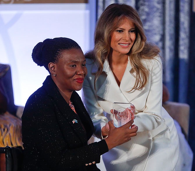 First lady Melania Trump presents the 2017 Secretary's of State's International Women of Courage (IWOC) Award to Malebogo Molefhe, from Botswana, Wednesday at the State Department in Washington. 