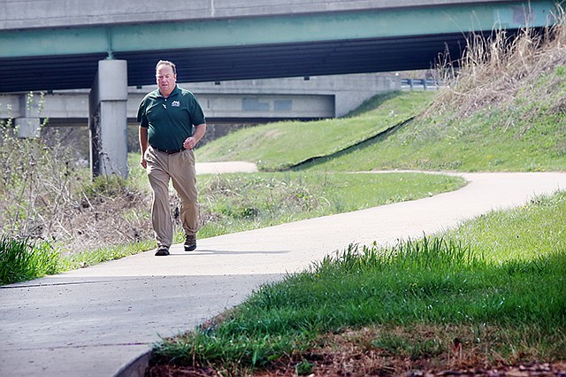Mike Rogers walks Wednesday, March 29, 2017, on the greenway trail near Dunklin Street in Jefferson City.