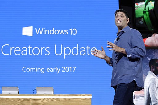 In this Wednesday, Oct. 26, 2016, file photo, Terry Myerson, Microsoft's executive vice president of the Windows and Devices Group, discusses a Windows 10 update at a Microsoft media event in New York. 