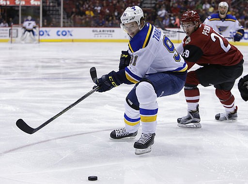 St. Louis Blues right wing Vladimir Tarasenko (91) shields Arizona Coyotes left wing Brendan Perlini from the puck in the first period during an NHL hockey game, Wednesday, March 29, 2017, in Glendale, Ariz.