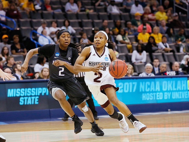 In this Friday, March 24, 2017 photo, Mississippi State guard Morgan William (2) drives past Washington guard Aarion McDonald (2) during the second half of a regional semifinal of the NCAA women's college basketball tournament in Oklahoma City. Women's basketball saw its lowest attendance for the regionals in 20 years and there is no change to the format in sight. 