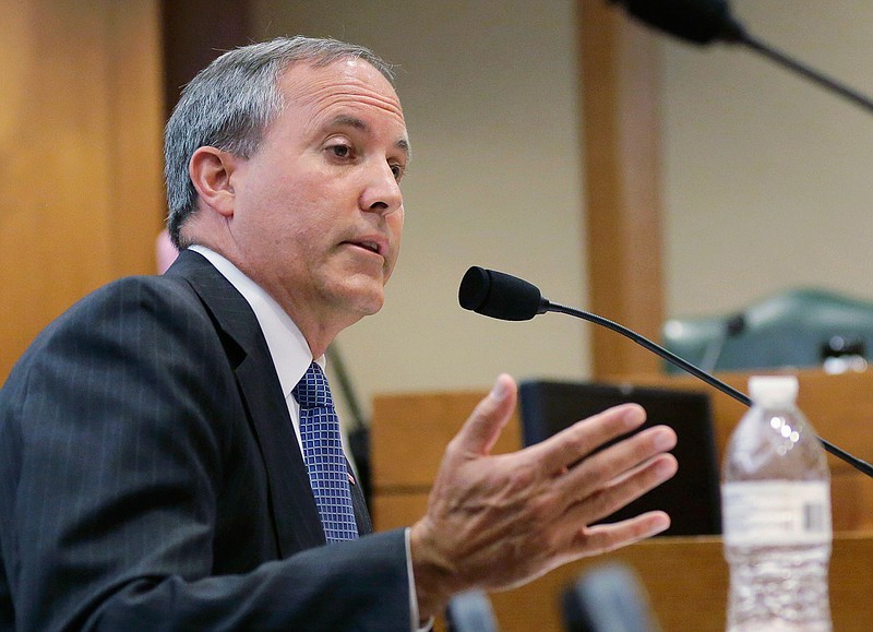In this July 29, 2015, file photo, Texas Attorney General Ken Paxton speaks during a hearing in Austin, Texas. On the brink of bringing Paxton to trial on felony securities fraud charges, the government's prosecutors are threatening to bail out of the case unless they get paid. Paxton, a stockbroker and state lawmaker before being elected attorney general two years ago, was indicted for allegedly steering investors to a technology startup in 2011 without disclosing that he was being paid by the company. The trial is scheduled to start May 1, 2017. 