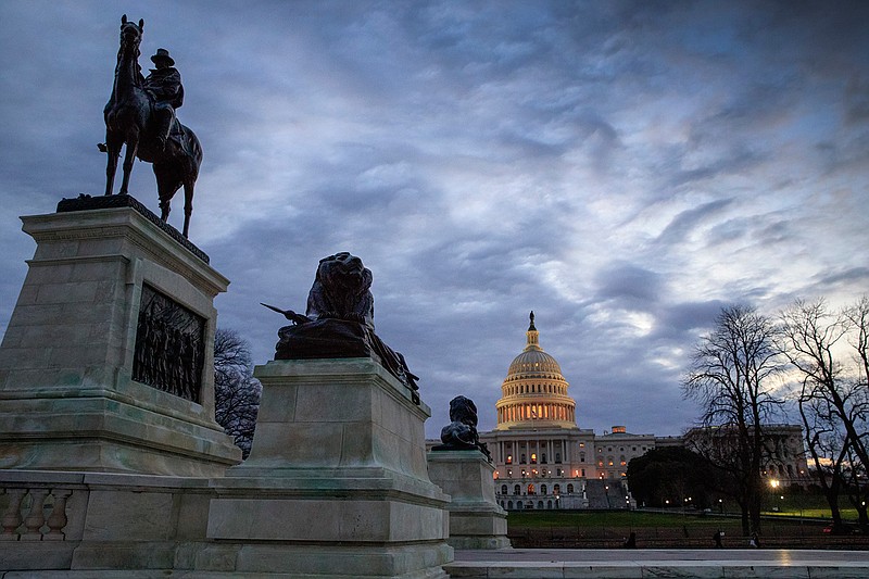 The Capitol, with a statue of Civil War General Ulysses S. Grant, left, is seen at dawn in Washington, Thursday, March 30, 2017. 