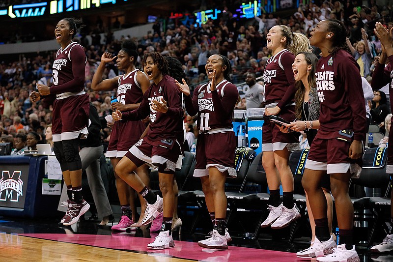 Mississippi State's Breanna Richardson (3), Teaira McCowan (15), Roshunda Johnson (11), Blair Schaefer (1) and the rest of the bench celebrate a basket against Connecticut during an NCAA college basketball game in the semifinals of the women's Final Four, Saturday, April 1, 2017, in Dallas. 