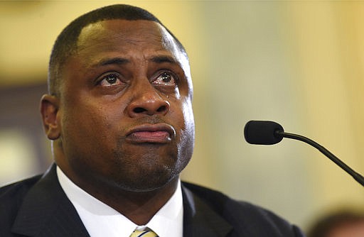 In this Dec. 2, 2014, file photo, National Football League (NFL) Executive Vice President of Football Operations Troy Vincent becomes emotional as he testifies on Capitol Hill in Washington, before the Senate Commerce Committee hearing on domestic violence in professional sports. 