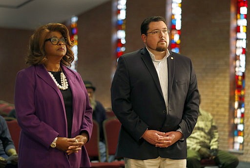 In this photo made Thursday, March 30, 2017, Ferguson Mayor James Knowles III, right, and councilwoman Ella Jones stand just off stage as they are introduced before a mayoral forum in Ferguson, Mo. Ferguson voters will head to the polls next week to pick between the two candidates for mayor. 