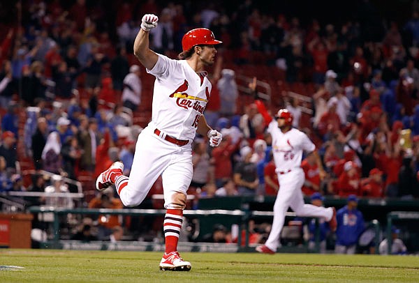 Randal Grichuk celebrates after hitting a walk-off single as Cardinals teammate Jose Martinez (back) comes in to score the winning run in a 5-4 victory against the Cubs on Sunday night at Busch Stadium.