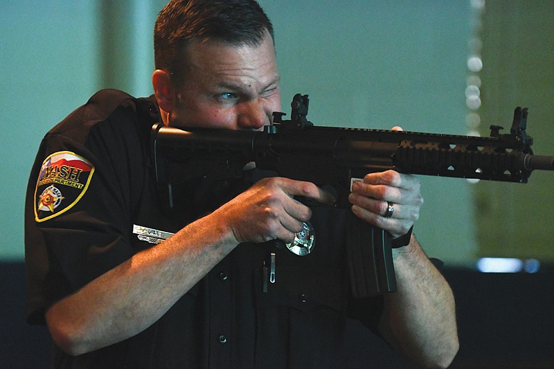 Nash Police Chief Kelly Dial runs through a school-shooter simulation using the Texarkana, Texas, Police Department's Laser Shot System Thursday at the TTPD Training Building. TTPD welcomed city managers and law enforcement members from East Texas to see the training facilities and courses available to them. 
