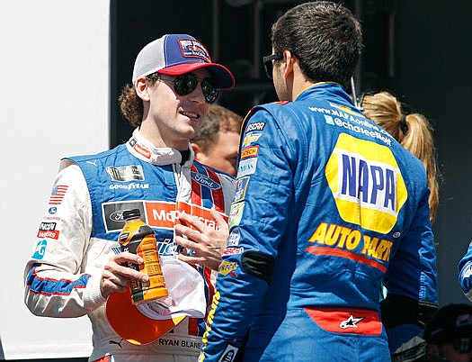 Ryan Blaney (left) talks with Chase Elliott before the start of the NASCAR Cup Series race last month at Phoenix International Raceway in Avondale, Ariz.