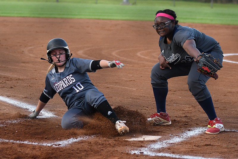 Liberty-Eylau's Savannah Phelps slides into home plate before Paris' Saya Swain can tag her out Tuesday at Lady Leopard Field at H.E. Markham Park in Texarkana, Texas. 