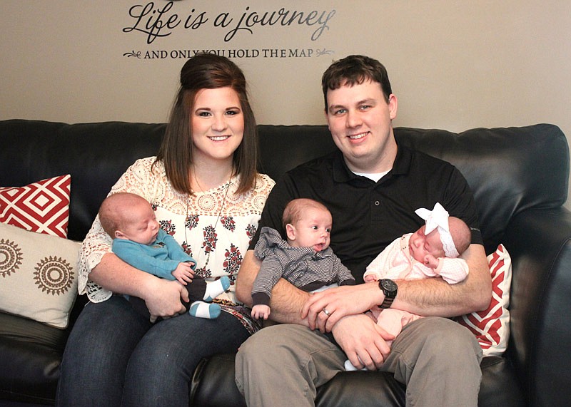 Amy and Jordan Hoecker hold triplets Briar, Barrett and Bentley.