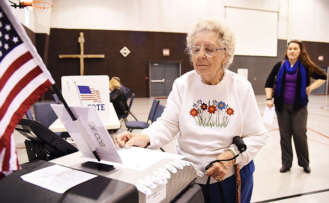 With her granddaughter, Kathleen McIlwain, standing behind her, Norma Jennings feeds her ballot to the electronic reader at Southridge Baptist Church. By 2 p.m. Tuesday, voting at that location had nearly reached 20 percent, so poll workers were expecting to reach the 25 percent turnout predicted by Cole County Clerk Steve Korsmeyer.