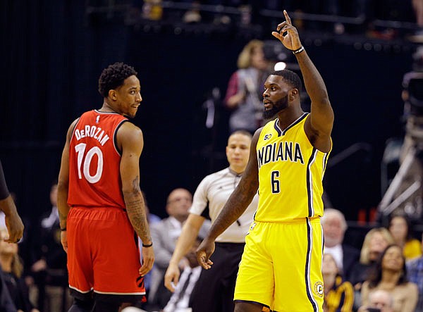 Pacers forward Lance Stephenson celebrates as Raptors guard DeMar DeRozan watches during the second half of Tuesday's game in Indianapolis. Stephenson scored a late layup in the final seconds of the Pacers' 108-90 win.