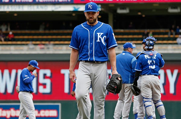 Royals pitcher Nate Karns heads to the dugout after he gave up a three-run triple to Miguel Sano of the Twins in the seventh inning of Wednesday's game in Minneapolis. The Twins won 9-1.
