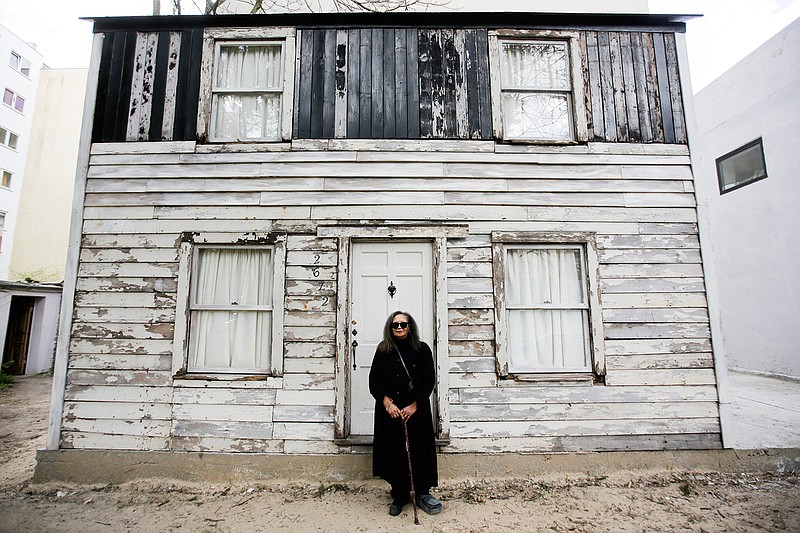 In this April 6, 2017 photo Rhea McCauley a niece of Rosa Parks poses in front of the rebuilt house of Rosa Parks in Berlin. McCauley donated the former Detroit house of Rosa Park to American artist Ryan Mendoza,, who has taken apart the  Michigan house that Rosa Parks once lived in and rebuilt it in the German capital, to raise awareness about the late civil rights activist and her legacy. 