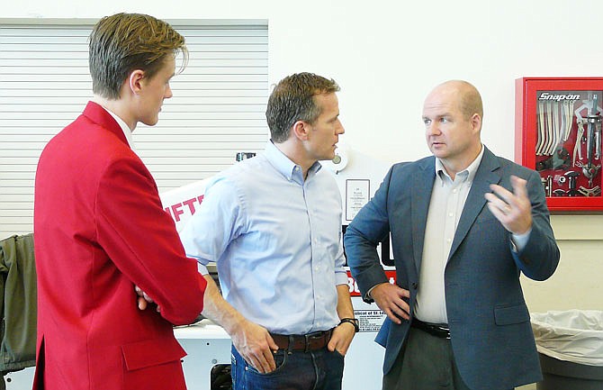 Braden Moser, left, listens as Gov. Eric Greitens, middle, speaks to State Tech President Shawn Strong during a visit Friday, April 7, 2017, to the technical school's main campus in Linn. Greitens was on hand for the SkillsUSA Competition hosted by State Technical College.