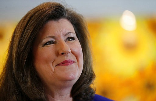 This May 14, 2014 file photo shows Karen Handel speaking to a reporter in Roswell, Ga. Candidates for a special congressional election in Georgia are demonstrating that Republican squabbling extends well beyond Capitol Hill, while their leading Democratic rival rakes in more than $8 million in campaign cash and eyes an upset that would send ripples through Washington ahead of the 2018 midterms. Handel is one of 11 Republican candidates, five Democrats and two independents, running to succeed Health Secretary Tom Price's seat. 