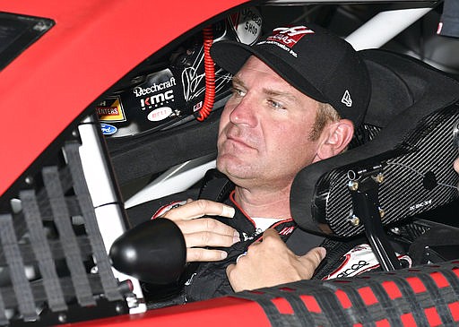 Clint Bowyer sits in his car during a practice session for Sunday's NASCAR Cup Series auto race a at Texas Motor Speedway in Fort Worth, Texas, Saturday, April 8, 2017. 