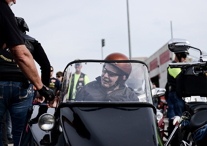 Eddie Doyle shakes hands Saturday with fellow motorcylists before they take him on a ride around Jefferson City. Doyle, who is in hospice care, is a former motorcycle enthusiast and wanted to go on one last ride, which was made possible by the American Legion Riders.