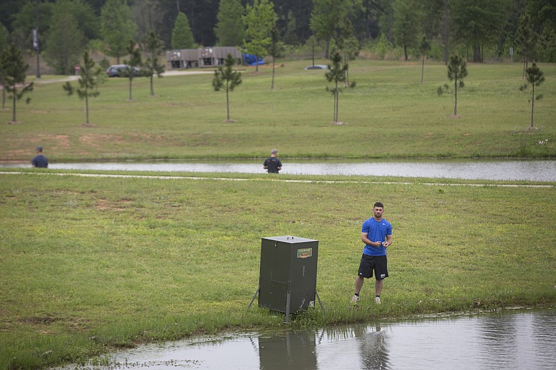 Kolton Perfect, Texas A&M University-Texarkana junior biology major and member of the Eagles baseball team, fishes Monday morning at the pond on the west side of the University Center in Texarkana, Texas. The group said they where killing time before their afternoon classes. 