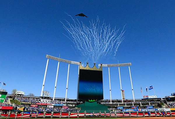 A B-2 bomber from Whiteman Air Force Base flies above the fireworks before Monday's game between the Royals and Athletics at Kauffman Stadium.