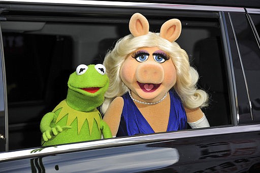 In this March 11, 2014, file photo, Kermit the Frog, left, and Miss Piggy arrive at the World Premiere of "Muppets Most Wanted," in Los Angeles. A New York City museum is asking fans of Jim Henson's Muppets to help pay for an exhibition featuring original puppets of beloved characters like Elmo, Miss Piggy and Kermit the Frog. The Museum of the Moving Image launched a Kickstarter campaign Tuesday, April 11, 2017, seeking $40,000 to help preserve the puppets for posterity. 