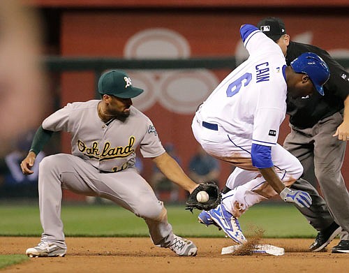 Lorenzo Cain of the Royals beats the tag at second byAthletics shortstop Marcus Semien after hitting a double during the fourth inning of Wednesday night's game at Kauffman Stadium.