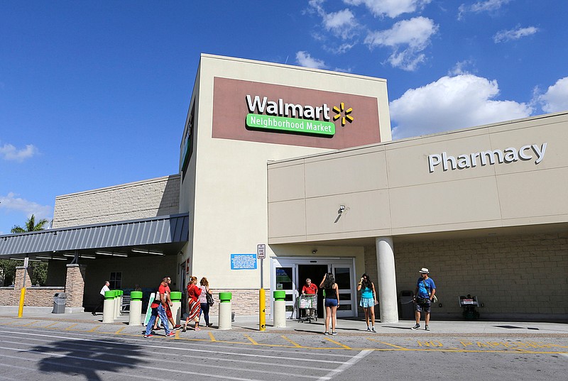 This Wednesday, Feb. 8, 2017, photo, shoppers enter a Wal-Mart neighborhood market, in Hialeah, Fla. Starting April 19, 2017, Wal-Mart says it will offer discounts on thousands of online-only items when customers elect to have them shipped to one of the company's stores for pickup.