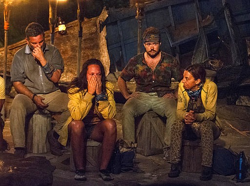 In this image released by CBS, contestants, from left, Jeff Varner, Sarah Lacina, Zeke Smith and Debbie Wanner appear at the Tribal Council portion of the competition series "Survivor: Game Changers." Smith was outed as transgender by fellow competitor Varner on Wednesday night's episode. Varner was immediately criticized by other players. He repeatedly apologized, but was voted out of the competition. 
