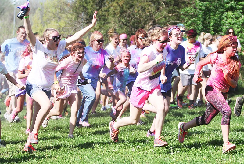 Patrons run at the starting line of the Paint the People 5K on Saturday, April 15, 2017 at Binder Park. Approximately 500 people attended the event hosted by the Jefferson City High School Key Club to raise money for the United Way.