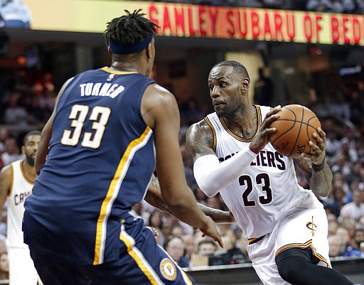 Cleveland Cavaliers' LeBron James (23) drives past Indiana Pacers' Myles Turner (33) in the first half in Game 1 of a first-round NBA basketball playoff series, Saturday, April 15, 2017, in Cleveland. 