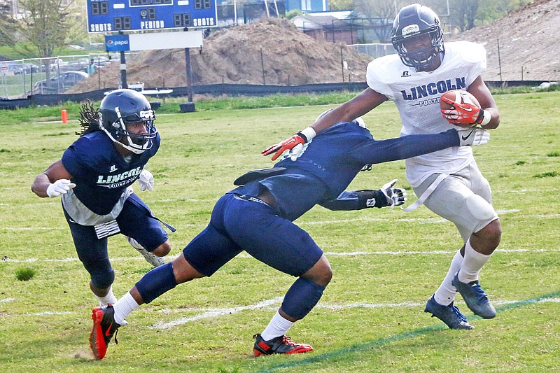 Lincoln University running back Eriq Torrey fends off potential tacklers during the team's Blue and White Game on Saturday afternoon, April 15, 2017 at the school's practice field.