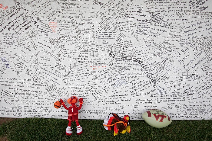 A memorial board sits under a tent in 2007 with items that were placed in front of it, on the Drillfield on the Virginia Tech campus in Blacksburg, Va. Ten years after a mentally ill student fatally shot 32 people at Virginia Tech, survivors and families of the slain are returning to campus to honor the lives that were lost that day. Virginia Tech is holding a series of events Sunday, April 16, 2017 to mark the anniversary of the deadly campus shooting on April 16, 2007.