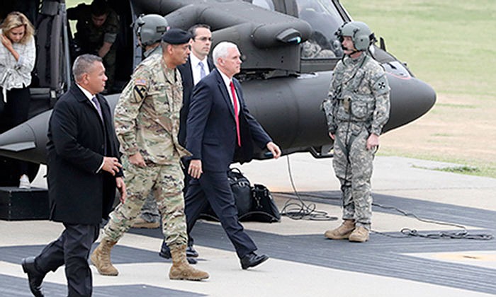 U.S. Vice President Mike Pence, center, arrives early Monday at Camp Bonifas outside of the Demilitarized Zone (DMZ), near the border village of Panmunjom in Paju, South Korea.