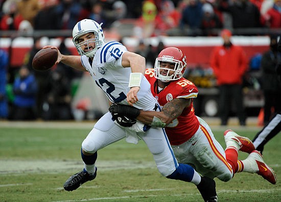 Derrick Johnson of the Chiefs tries to bring down Colts quarterback Andrew Luck during a 2013 game at Arrowhead Stadium.