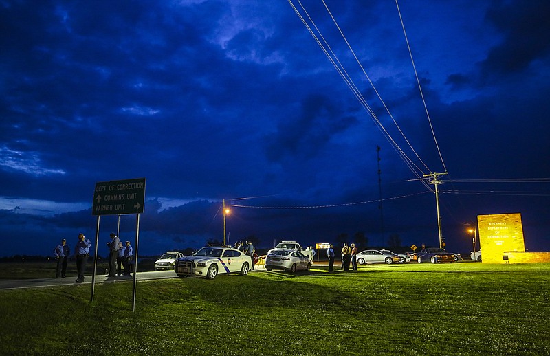 In this Monday evening, April 17, 2017 photo, the sun sets behind clouds over an Arkansas State Police command post outside the Varner Unit of the Arkansas Department of Correction near Varner, Ark. As state officials prepare to carry out a double execution Thursday ahead of a drug expiration deadline and despite the setback the U.S. Supreme Court delivered late Monday, lawyers for those condemned men look to be taking a different approach: claiming the prisoners are actually innocent.