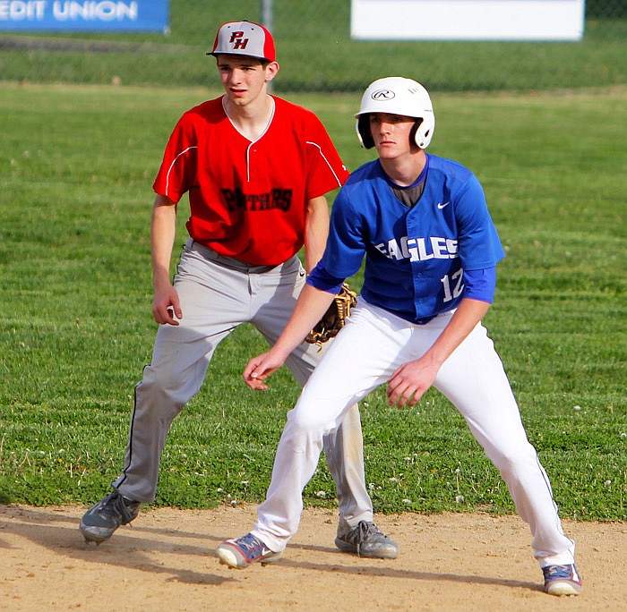 Jamestown's Garrett Wolfe takes a lead off second base Wednesday, April 12, 2017 while Prairie Home shortstop Clayton Pethan looks for a possible pick off throw.