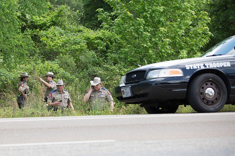 Texas Department of Public Safety troopers collect evidence following a manhunt Wednesday along U.S. Highway 59. During a traffic stop, the passenger in the vehicle allegedly fled on foot, sparking a roughly three-hour search. Michael Basham from Aledo, Texas, was apprehended and transported to the Bi-State Justice Building. The search caused Liberty-Eylau Primary School to be put on lockdown. 