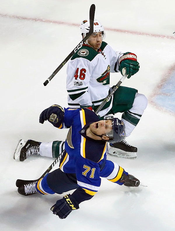 Vladimir Sobotka of the Blues loses his stick after colliding with the Wild's Jared Spurgeon during the third period Wednesday in Game 4 of the Western Conference first-round playoffs in St. Louis. The Wild won 2-0.