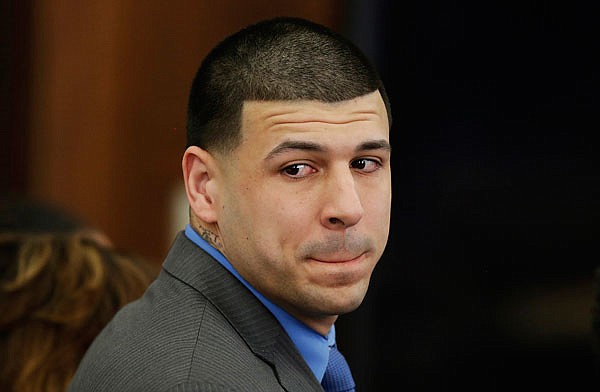 In this April 14 file photo, former New England Patriots tight end Aaron Hernandez turns to look in the direction of the jury as he reacts to his double murder acquittal at Suffolk Superior Court in Boston. Hernandez hung himself and was pronounced dead at a Massachusetts hospital early Wednesday, according to officials.