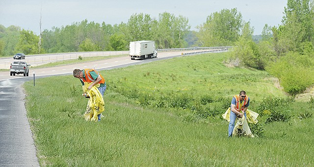 As part of activities to mark the 30th anniversary of the Adopt-A-Highway Program on Thursday, May 18, 2017, a brief ceremony on the parking lot of Miller Performing Arts Center was followed by Bartlett & West engineers going to the shoulder of U.S. 63 to pick up litter and roadside debris. Jason Sommerer, right, and Dave Straatmann were just two in the group who participated in the cleanup.