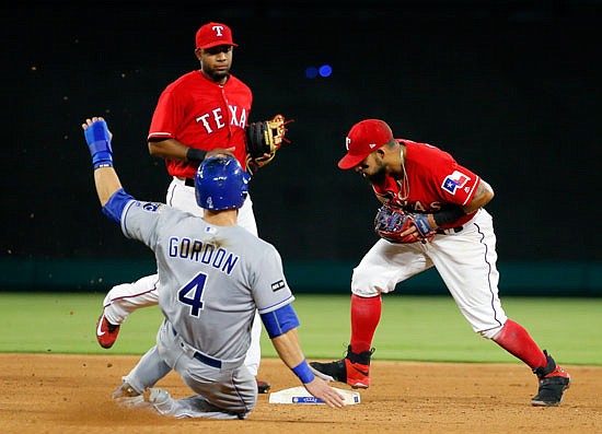 Alex Gordon of the Royals is forced out at second by Rougned Odor of the Rangers as shortstop Elvis Andrus watches during the eighth inning of Thursday night's game in Arlington, Texas.