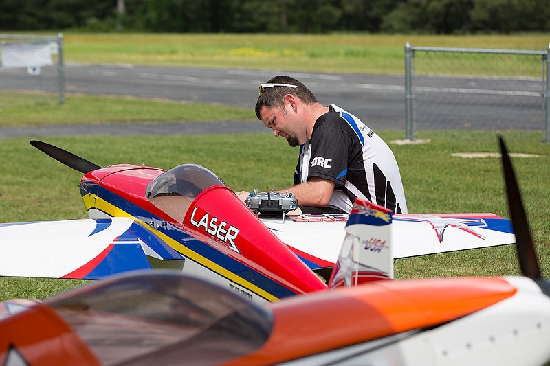 Blake Brown of Paragould, Ark., prepares his Laser 230Z remote-controlled airplane Friday afternoon at the RC Flying field at Wright Patman Lake. The Texarkana Radio Control Flying Club is holding their annual Fly the Line event this weekend. The group has changed the name from the Big Bird Fly-In and expanded the types of RC planes that can participate to attract more pilots. Spectators are welcome. Organizers say previous years have drawn as many as 100 pilots. Activities are scheduled throughout today, including night flights. The weekend of flying officially wraps up at 1 p.m. Sunday.
