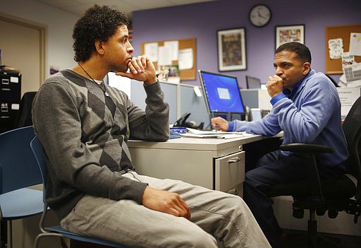 In this Thursday, April 20, 2017 photo, Neftali Thomas Diaz, left, talks with his case manager, David Rodriguez, at The Fortune Society in New York. New York City is betting that Diaz and other low-level offenders like him are right about the salvation in second-chance employment.