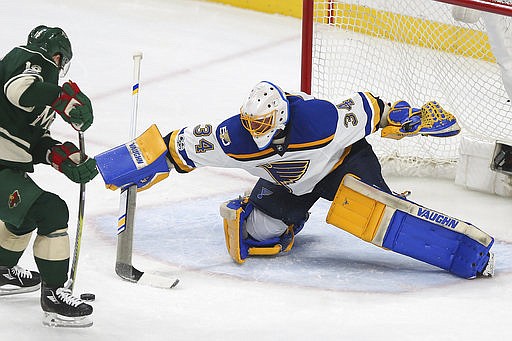 St. Louis Blues' goalie Jake Allen (34) tries to block the shot of Minnesota Wild's Jason Zucker (16) during the second period of Game 5 of an NHL hockey Stanley Cup first-round playoff series Saturday, April 22, 2017, in St. Paul, Minn.