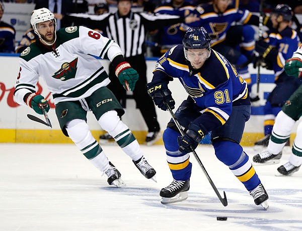 Vladimir Tarasenko of the Blues brings the puck down the ice as the Wild's Marco Scandella watches during the second period Wednesday in Game 4 of the Western Conference first-round playoffs in St. Louis.