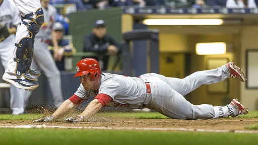 St. Louis Cardinals' Jedd Gyorko slides home safely after hitting a triple and then scoring on a throwing error during the ninth inning of a baseball game Saturday, April 22, 2017, in Milwaukee. The Cardinals beat the Brewers 4-1.